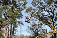 Are you tired of climbing towers and hanging off by a belt.  Try this scissor lift up to about 50 feet. In the photo W5EZT and N5JGK are going up to straighten the reflector of a 20 meter beam that was whacked by a falling tree. (photo by W5XX)