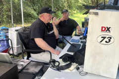 The Mississippi Coast ARA operated Field Day 4A from the woods near the N5LBZ QTH. In the photo AG5ZH runs the SSB pileups while N5FTY cheers him on. (photo provided by the MCARA Splatter)