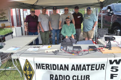 The Meridian ARC was invited to set up a booth at Collinsville Day to promote Ham Radio. In the photo (L-R) W4IOS, KI5HCM, KG5IAX, KB5SZJ, KI5ZLP, K5BHW and W5MAV (front). (Photo provided by W5MAV)