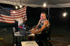 The Jackson County ARA operated Field Day from the Central Jackson County Safe House at Vancleave. In the photo W5SMN works SSTV on the night shift from his tent set up outside the Safe House. (photo provided by N2PKW)