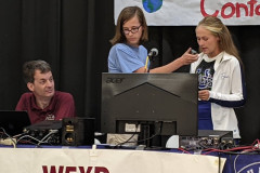 The International Space Station visited Mississippi on August 22. Bayou Academy in Cleveland, MS was selected to participate in the Amateur Radio on the International Space Station (ARISS) program. Bayou Academy hosted the historic event supported by a collaborative effort involving members from MSU ARC, the Magnolia ARC, and the Lowndes County ARC. In the photo WT5A helps a student with a question for orbiting NASA Astronaut Sunni Williams while in the background N4OGW mans the down link station. (Photo provided by AG5ND)