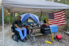 The Jackson County ARA conducted a POTA Campout from Shepard State Park in Gautier (K-2551) on November 17-19. In the photo W5SMN gets ready to pass out POTA QSOs from his camp site. See ParksOnTheAir.com for more POTA info. (photo provided by WF5W)